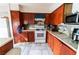 A kitchen view with stone floors and backsplash, wood cabinets, and appliances at 2612 Sonora St, Las Vegas, NV 89102