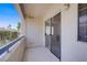 Cozy outdoor balcony featuring tiled flooring, a white door, and sliding glass doors at 2725 S Nellis Blvd # 1056, Las Vegas, NV 89121