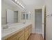 Well-lit bathroom featuring a double sink vanity, a mirror, and a walk-in shower at 2725 S Nellis Blvd # 1056, Las Vegas, NV 89121