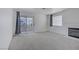 Spacious living room featuring neutral tones, fireplace, and sliding glass doors to a private balcony at 2725 S Nellis Blvd # 1056, Las Vegas, NV 89121