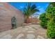 Tranquil backyard featuring an elegant fountain, mature palm tree, and well-maintained landscaping, providing privacy at 2820 Goldcreek St, Henderson, NV 89052
