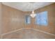 Dining room featuring a chandelier, tile floors, neutral paint, and views from two windows at 2820 Goldcreek St, Henderson, NV 89052