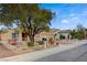 Charming single-story home showcasing desert landscaping, a spacious driveway, and mature trees at 2820 Goldcreek St, Henderson, NV 89052