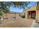 Spacious front yard showcasing desert landscaping, a covered porch, and mature trees at 2820 Goldcreek St, Henderson, NV 89052