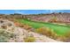 Picturesque golf course winding through desert landscape, with rolling hills and well-maintained fairways at 2820 Goldcreek St, Henderson, NV 89052