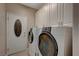 Well-equipped laundry room with modern washer, dryer, and ample storage cabinets at 2820 Goldcreek St, Henderson, NV 89052