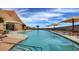 Resort-style pool featuring lounge chairs, sun umbrellas, and scenic mountain views, for luxurious relaxation at 2820 Goldcreek St, Henderson, NV 89052