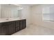 Bathroom with double vanity, tiled floors, and sliding glass shower doors at 2824 Mozia Ct, Henderson, NV 89044