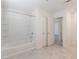 Bathroom features white tub and shower combo, tiled floors, and closet space at 2824 Mozia Ct, Henderson, NV 89044