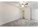 A spacious bedroom featuring a closet, ceiling fan, and carpet flooring at 2824 Mozia Ct, Henderson, NV 89044