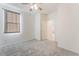 A sunny bedroom features carpet, a ceiling fan, and a neutral color palette at 2824 Mozia Ct, Henderson, NV 89044