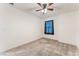 Bedroom with carpet flooring, a ceiling fan, and a large window with blinds at 2824 Mozia Ct, Henderson, NV 89044