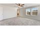Spacious bedroom with two windows, gray carpet, and an adjacent hallway at 2824 Mozia Ct, Henderson, NV 89044