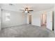Large bedroom with gray carpet, ceiling fan, closet and an adjacent hallway at 2824 Mozia Ct, Henderson, NV 89044