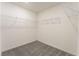 Walk-in closet features white walls, gray carpet and shelving units at 2824 Mozia Ct, Henderson, NV 89044