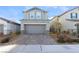 Beautiful two-story home featuring a paved driveway, attached garage, and a landscaped front yard at 2824 Mozia Ct, Henderson, NV 89044
