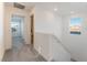Carpeted hallway with access to multiple rooms and plenty of natural light at 2824 Mozia Ct, Henderson, NV 89044