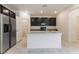 Bright kitchen showcases an island, stainless steel refrigerator, and ample cabinet space for storage at 2824 Mozia Ct, Henderson, NV 89044