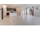 Open floor plan with a view of the kitchen, tile floors, and sliding door to the backyard at 2824 Mozia Ct, Henderson, NV 89044