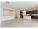 Spacious living room with tile flooring and a view into the kitchen area for open concept living at 2824 Mozia Ct, Henderson, NV 89044