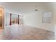 Bright living room featuring tile flooring, a sliding glass door and neutral paint at 2824 Mozia Ct, Henderson, NV 89044