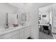 Bright bathroom features double sink vanity, large mirror, and view to a nearby home office at 2935 Gaffer Film St, Las Vegas, NV 89156