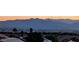 Scenic view of the cityscape and distant mountains at sunset, palm trees dotting the foreground at 2935 Gaffer Film St, Las Vegas, NV 89156