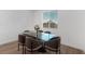Dining room features glass table with seating near a bright window overlooking neighborhood at 2935 Gaffer Film St, Las Vegas, NV 89156