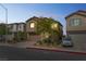 Two-story home featuring a large driveway, attached two-car garage, and landscaped front yard at 2935 Gaffer Film St, Las Vegas, NV 89156