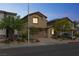 Charming two-story home with a paver driveway, desert landscaping, and a two-car garage at dusk at 2935 Gaffer Film St, Las Vegas, NV 89156