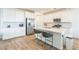 Modern kitchen features white cabinets, stainless steel appliances, and a center island with barstool seating at 2935 Gaffer Film St, Las Vegas, NV 89156
