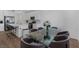 Open concept kitchen boasts white cabinets, stainless appliances, marble island with seating and adjacent dining at 2935 Gaffer Film St, Las Vegas, NV 89156