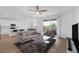 Open-concept living room with modern furnishings, a ceiling fan, and lots of natural light at 2935 Gaffer Film St, Las Vegas, NV 89156