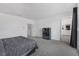 This spacious main bedroom features grey carpet, a large window, and a black chest of drawers at 2935 Gaffer Film St, Las Vegas, NV 89156