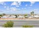 Scenic neighborhood street view with palm trees under a beautiful blue sky with distant mountains at 2935 Gaffer Film St, Las Vegas, NV 89156