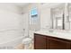 Bathroom featuring a white tub/shower, wood vanity, and large mirror at 3526 Harbor Tides St, Las Vegas, NV 89147