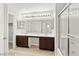 Bright bathroom showcasing double sinks, wood cabinets, a large mirror, and glass-enclosed shower at 3526 Harbor Tides St, Las Vegas, NV 89147