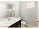 Bathroom featuring a white sink, dark cabinetry, and shower at 3526 Harbor Tides St, Las Vegas, NV 89147