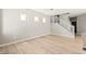 Living room with wood-look flooring, staircase, and neutral paint scheme at 3526 Harbor Tides St, Las Vegas, NV 89147