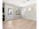 Spacious and airy living room area with wood-look floors and access to an outdoor space at 3526 Harbor Tides St, Las Vegas, NV 89147