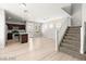 Bright, open-concept living space with wood-look floors, stairs, and a kitchen with stainless steel appliances at 3526 Harbor Tides St, Las Vegas, NV 89147