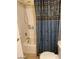 Bathroom featuring a shower with curtain, toilet, and storage shelves at 4150 Solteros St, Las Vegas, NV 89103