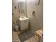 Bathroom with neutral walls, white vanity with sink, grey rug, and tiled floors at 4150 Solteros St, Las Vegas, NV 89103