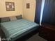 Bedroom with a double bed, side table, black curtains, and a dark wooden dresser at 4150 Solteros St, Las Vegas, NV 89103
