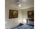 Cozy bedroom featuring neutral walls, framed artwork, and ceiling fan above a bed at 4150 Solteros St, Las Vegas, NV 89103