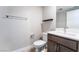 Bathroom features modern vanity, toilet, and towel rack, accentuated by minimalist shelving and clean lines at 4294 Eagle Summit Ave, Las Vegas, NV 89141
