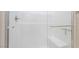 Modern shower with clear glass enclosure and horizontal white tiling, showcasing clean lines and minimalist design at 4294 Eagle Summit Ave, Las Vegas, NV 89141