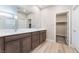 Bathroom featuring double sink vanity with modern fixtures, and a view into the walk-in closet at 4294 Eagle Summit Ave, Las Vegas, NV 89141