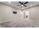 Spacious bedroom featuring plush gray carpet, a ceiling fan, and access to an en-suite bathroom at 4294 Eagle Summit Ave, Las Vegas, NV 89141