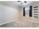 Neutral bedroom featuring carpet, a ceiling fan and modern wall shelves at 4294 Eagle Summit Ave, Las Vegas, NV 89141